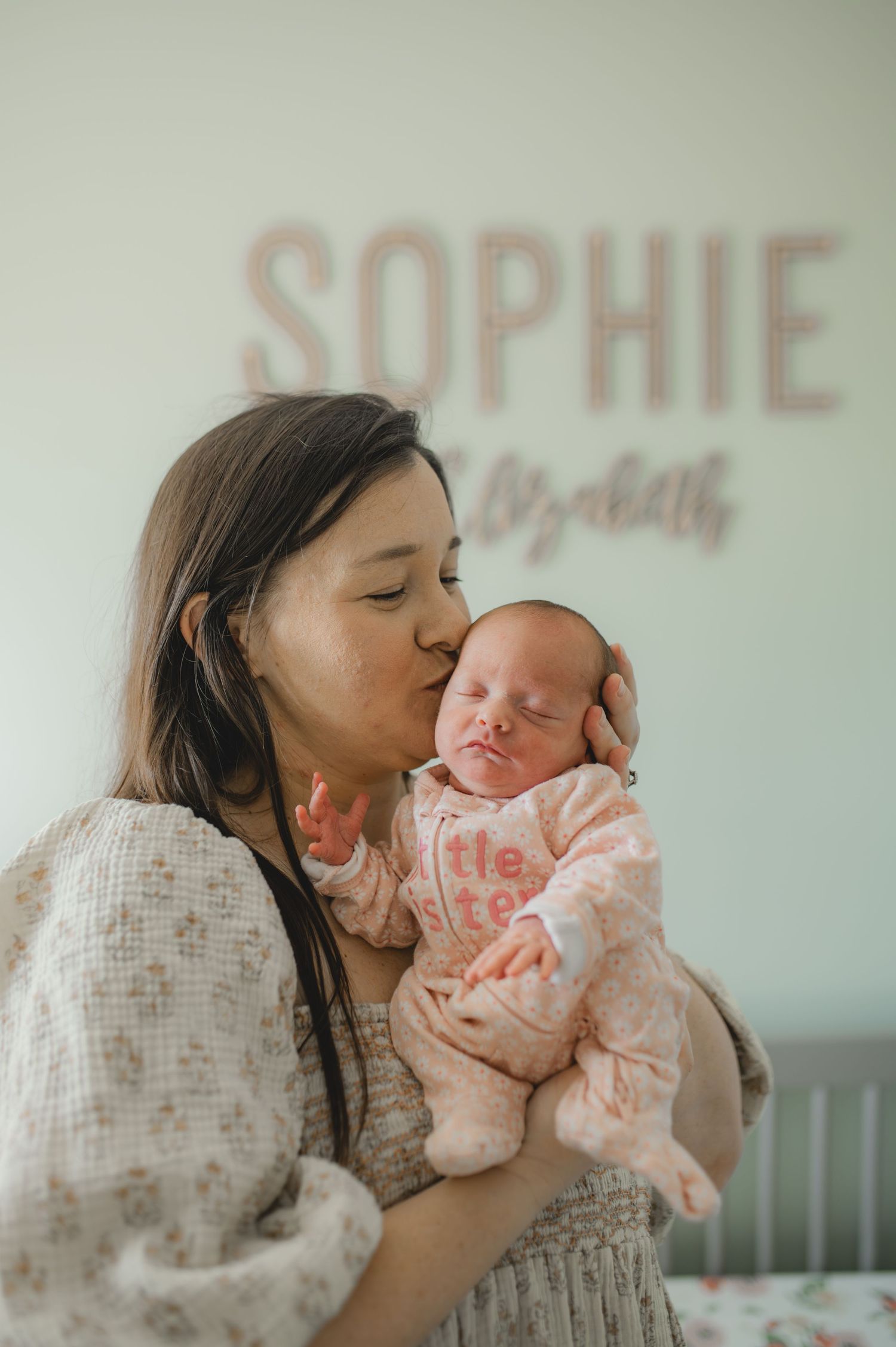 mom and baby standing in front of crib in nursery, greenville, nc, newborn photographer