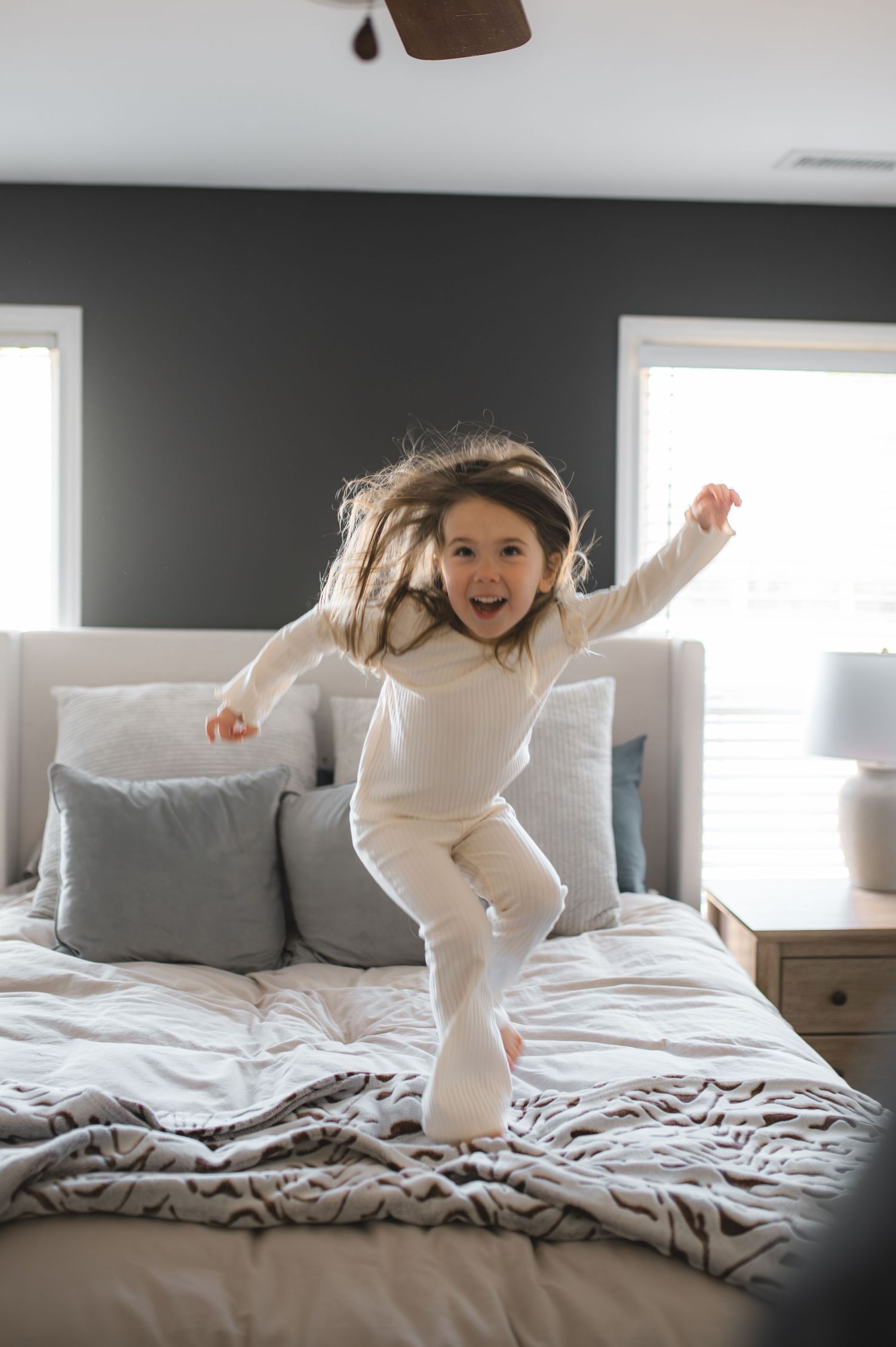 child jumping on bed, greenville, nc