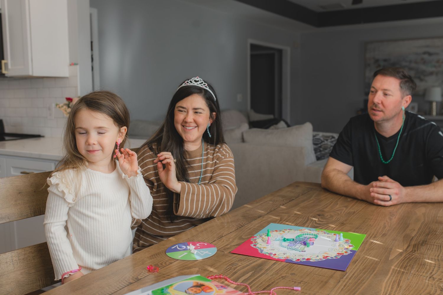 mom and child wearing tiara and earring for board game, laughing, greenville, nc