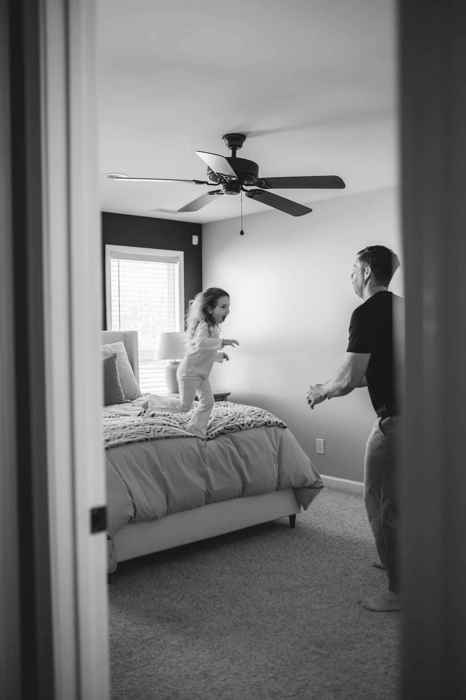 child and dad jumping on bed, greenville, nc