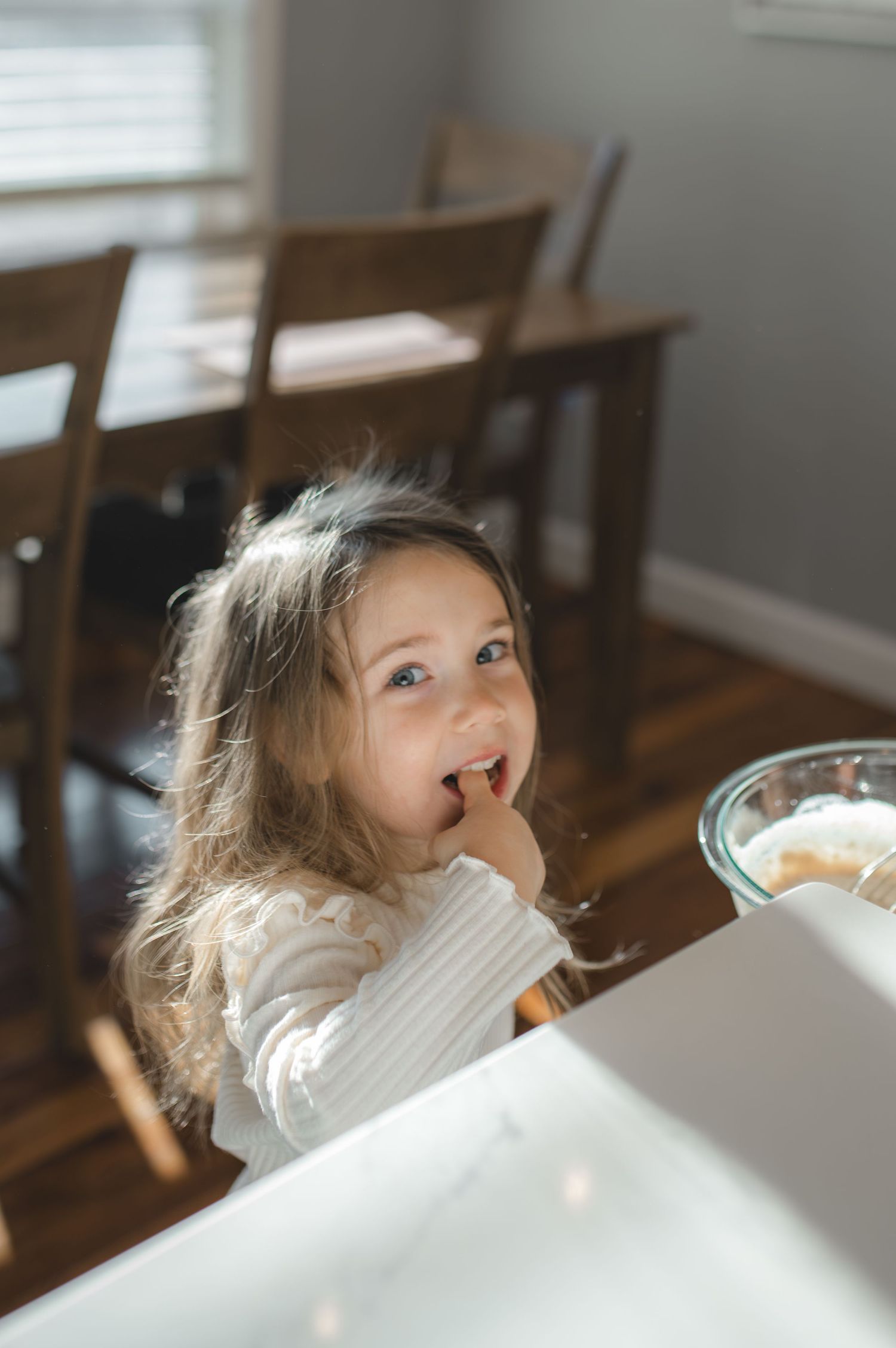 little girl trying pancake batter out of the bowl, greenville, nc