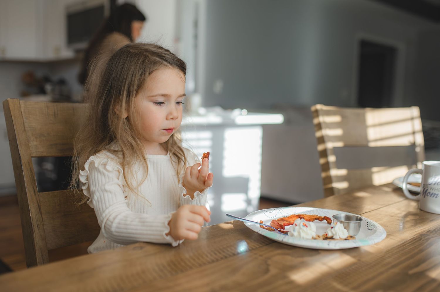 little girl eating breakfast at kitchen table, greenville, nc