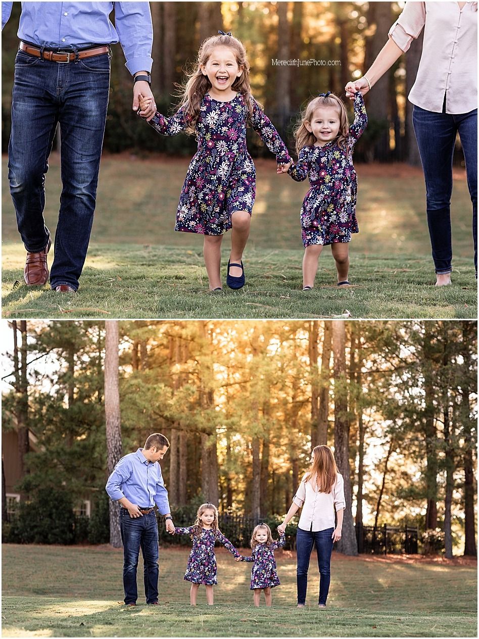 A family walks together in a grassy field at sunset with trees in the background.