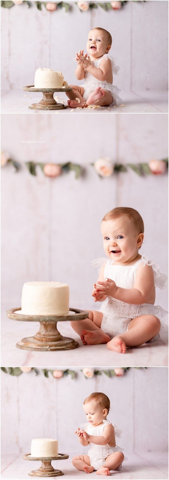 Baby in white lace outfit explores white cake during cake smash photo session.