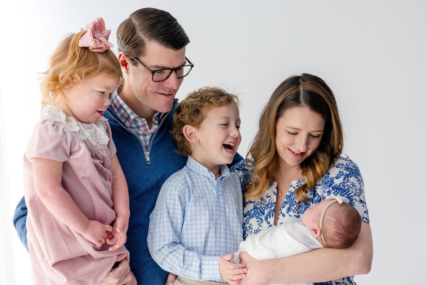 A series of candid family photographs showing tender moments between parents and children in casual home settings.