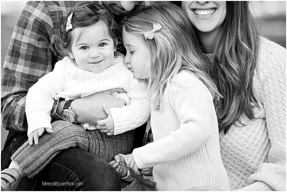 A series of black and white photos showing tender moments between a baby and caregiver in casual attire.