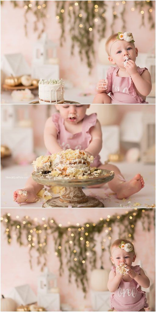 Cake smash photo session with pink decorations and twinkling lights in the background.