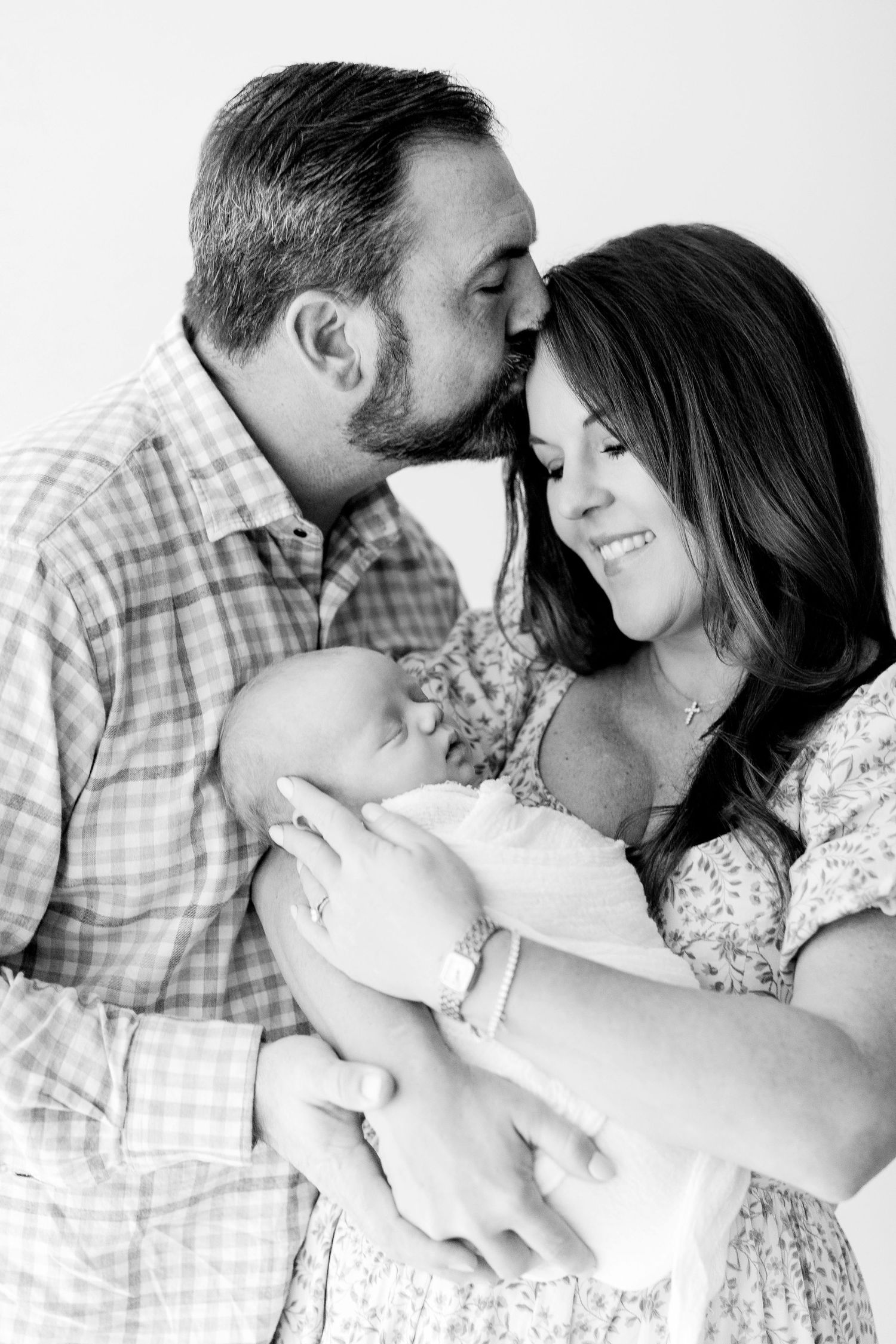 A romantic black and white photo series showing tender moments between a couple in casual attire.