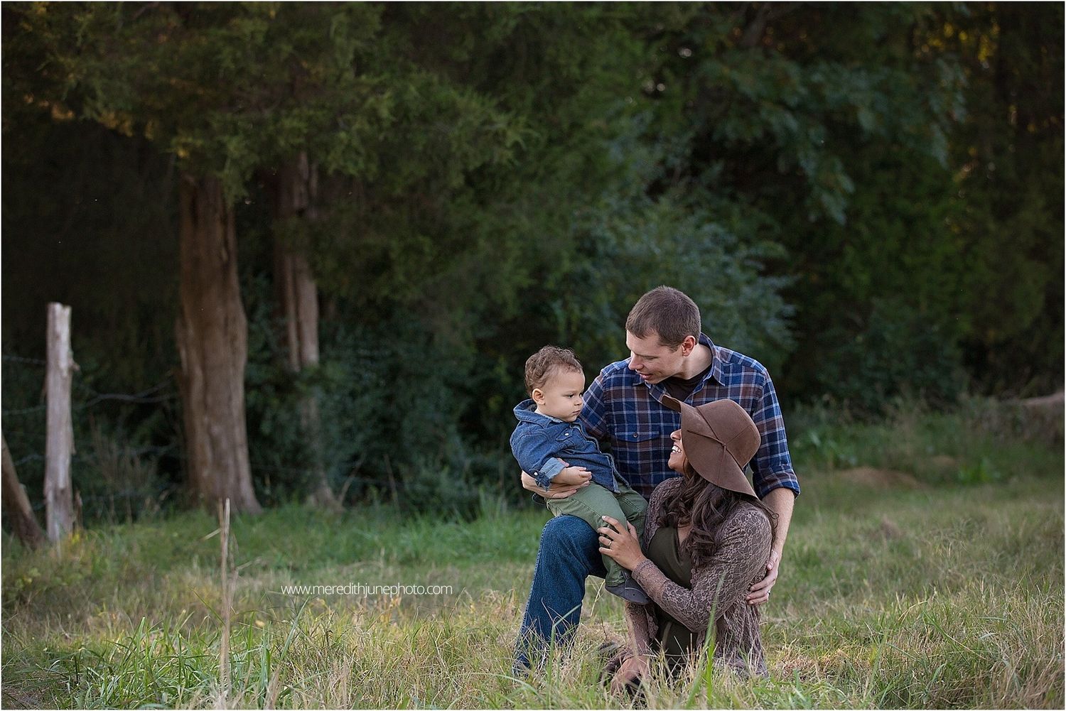 A couple embraces in a romantic outdoor photoshoot series amidst a natural wooded setting.