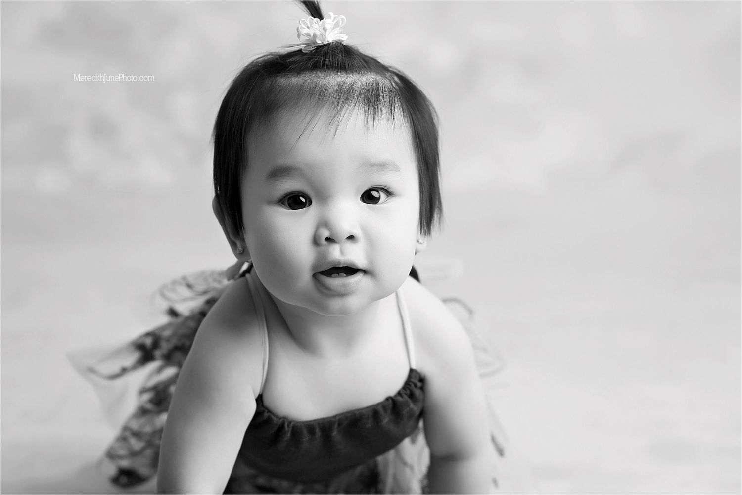 A black and white photo collage showing a baby's expressions and poses at different moments.