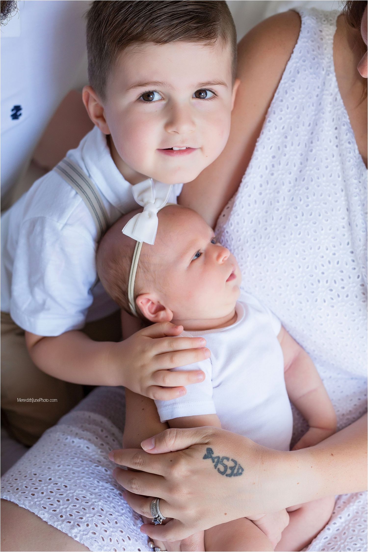A series of images showing a baby being fed with a nasal aspirator or medicine dropper while being held in white clothing.