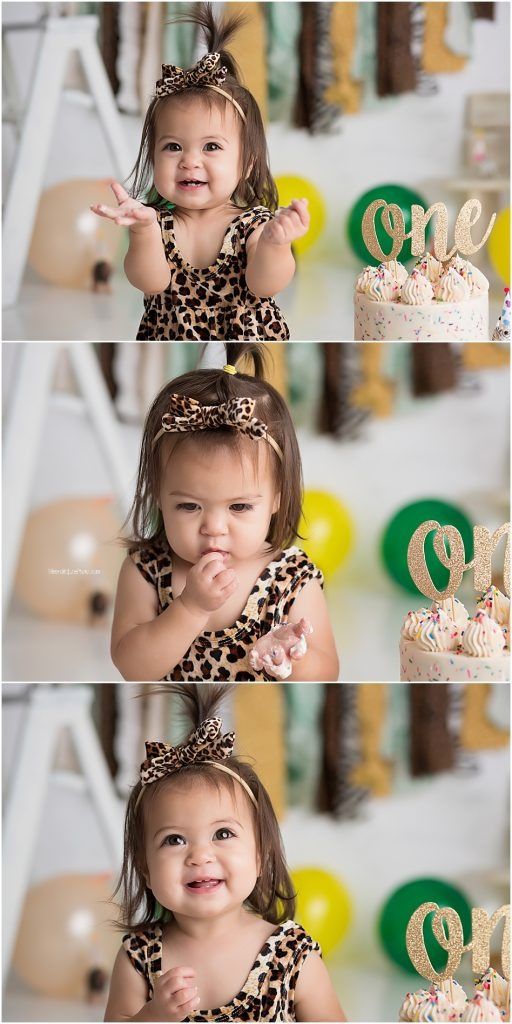 First birthday celebration with leopard print outfit and gold decorations against white backdrop.