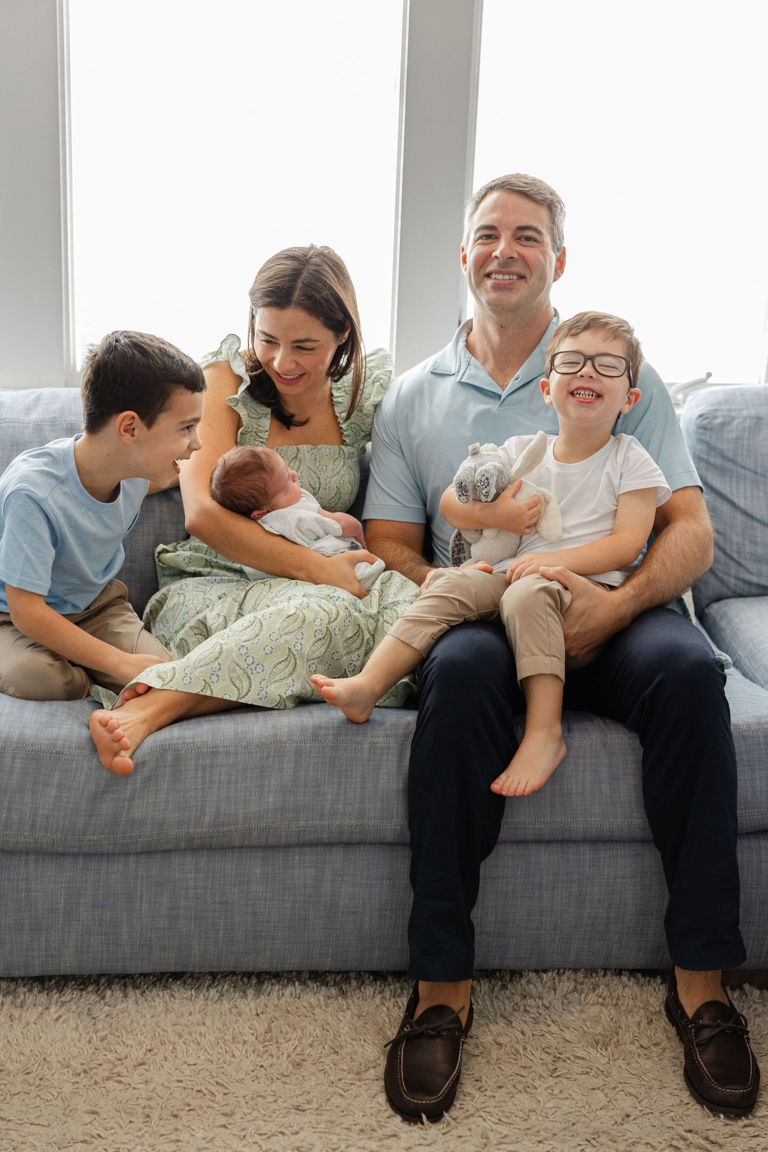 A series of candid photos showing playful interactions between parent and child on a gray couch.