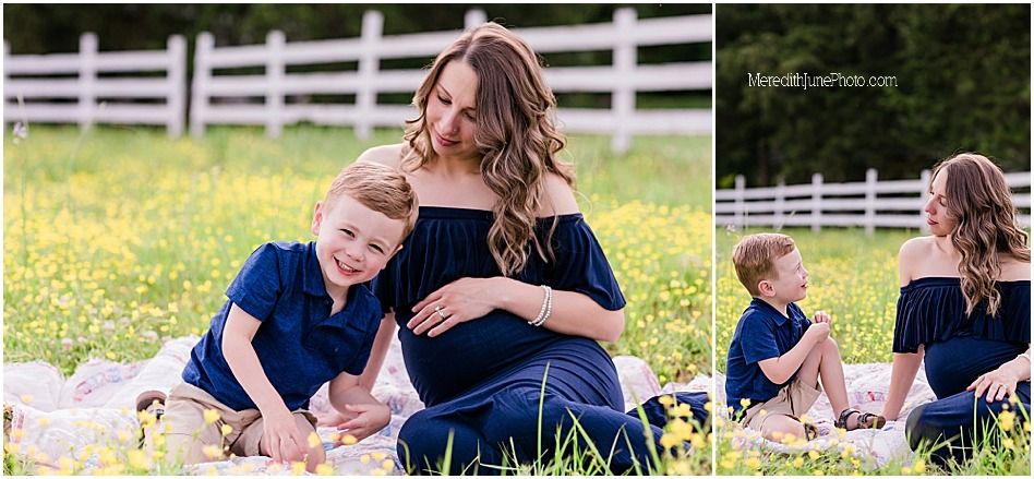 Family relaxing in a grassy field with white fence visible in background during golden hour.
