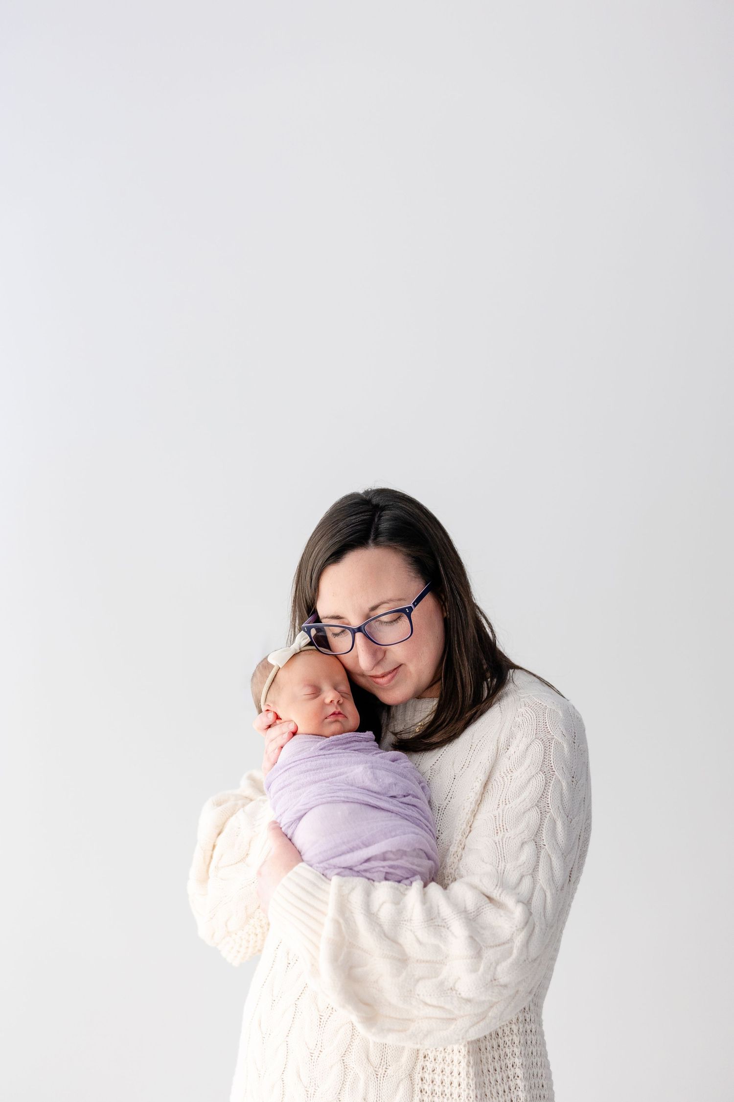 A series of three photos showing a tender embrace in a white sweater against a light background.