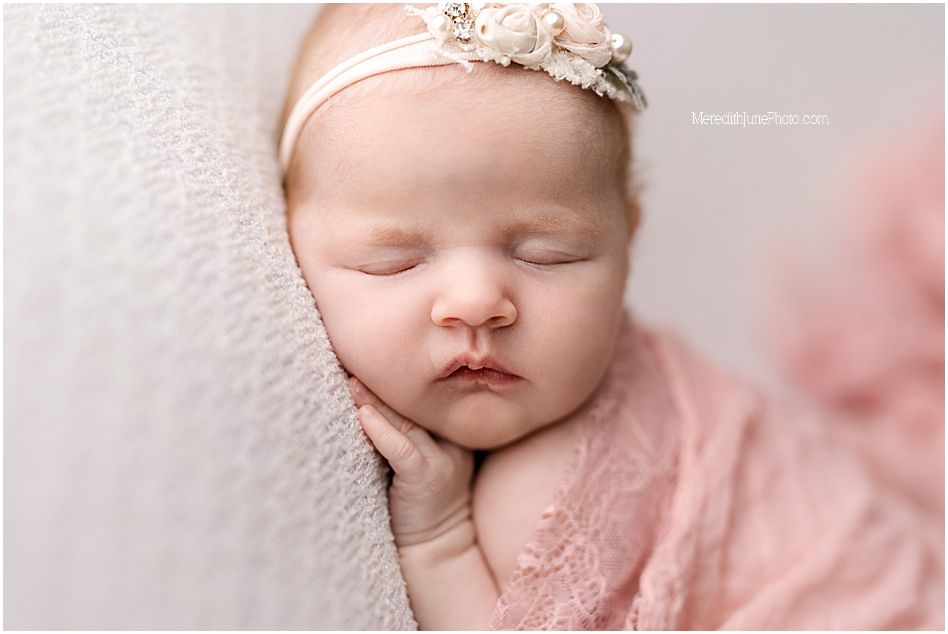 Delicate newborn photography collection featuring soft pink tones and floral headband accessories.