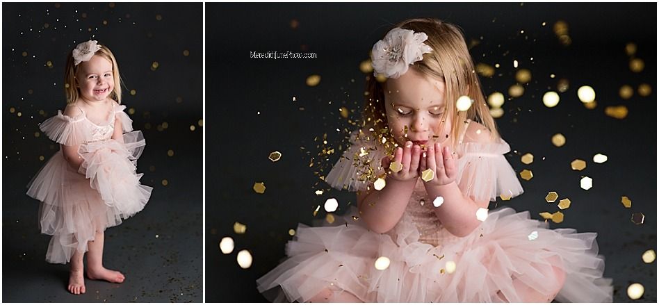 A child wearing a pink tulle dress twirls against a dark background with glowing bokeh lights.
