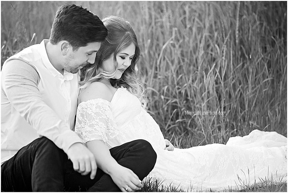 Black and white romantic couple photos in tall grass field showing intimate moments and tender embraces.