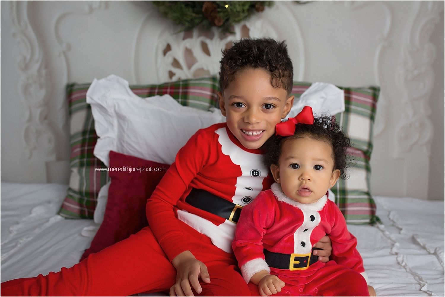 Seven Christmas-themed photos showing children in matching red and white holiday outfits posing on a white bed.