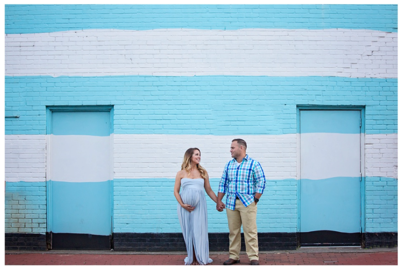 Modern engagement photography session against vibrant blue and white painted walls.