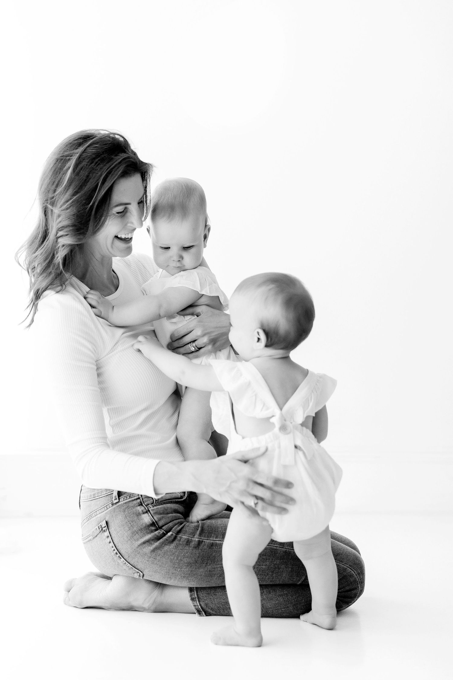 Black and white series of parent and baby interacting on white background.