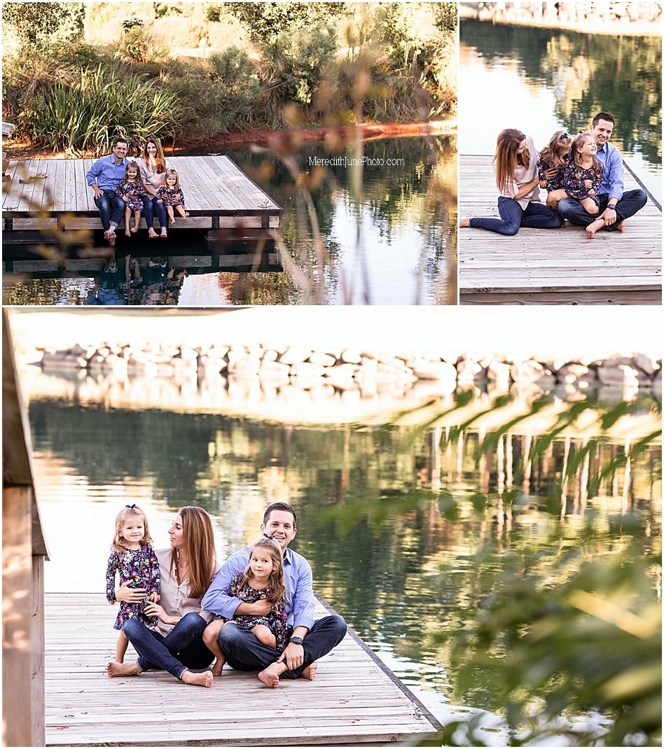 A group relaxes on a wooden dock by a tranquil lake during a sunny afternoon.