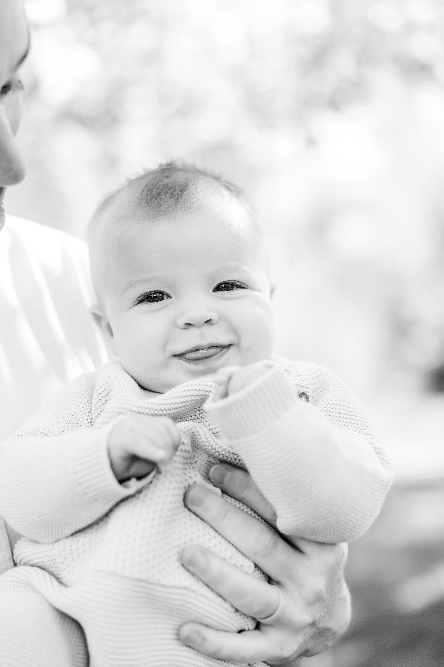 Close-up black and white portraits showing baby's expressions and smiles.