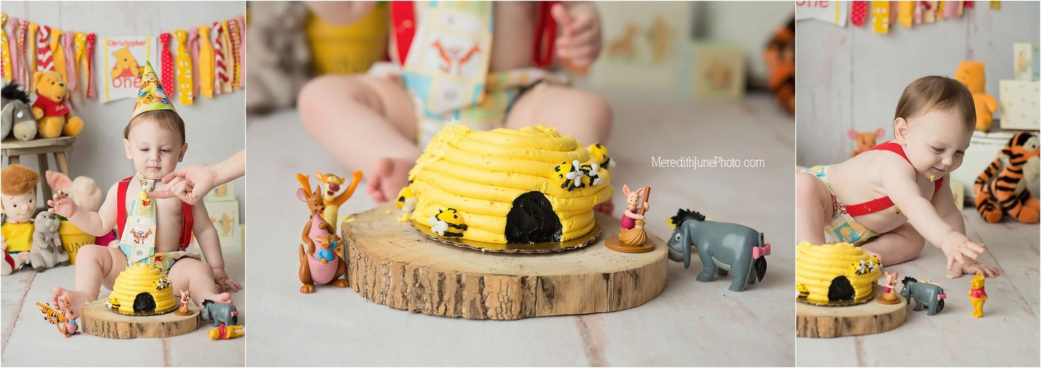 A woodland-themed birthday cake with mushroom decorations sits on a rustic wood slice cake stand.