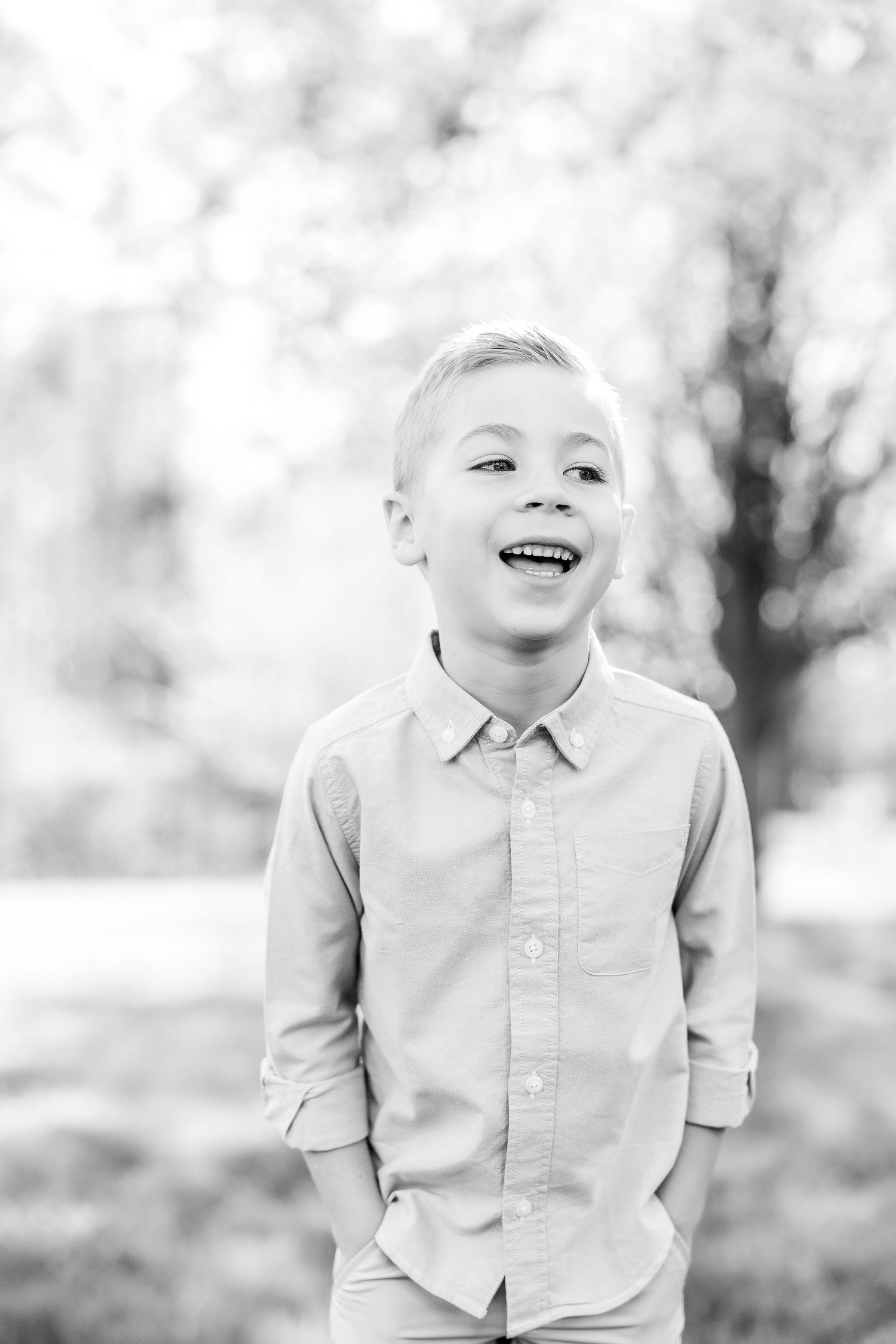 Series of black and white photos showing joyful expressions and laughter in an outdoor setting.