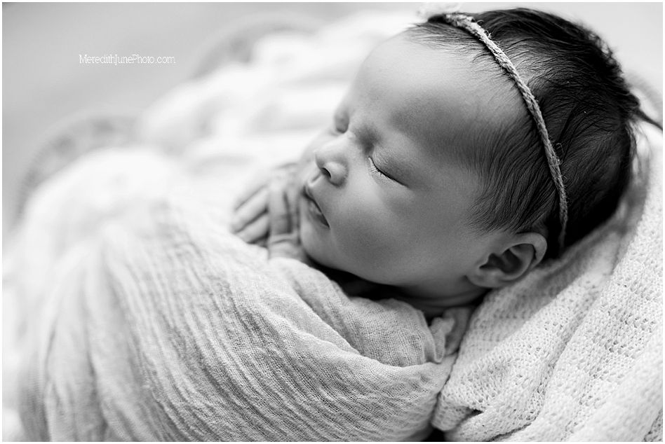 Black and white portrait series of sleeping newborn baby with delicate features and soft lighting.
