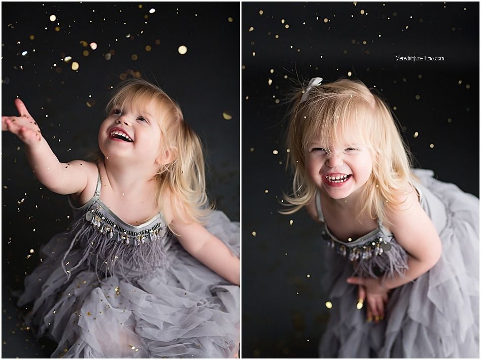 Joyful expressions and movement captured in a sparkly photo session against a dark background with grey tulle dress.