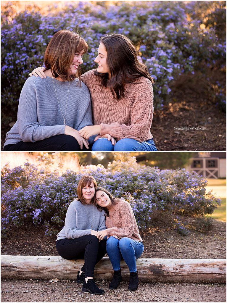 Two people share intimate moments outdoors among purple flowers during a sunset photo session.