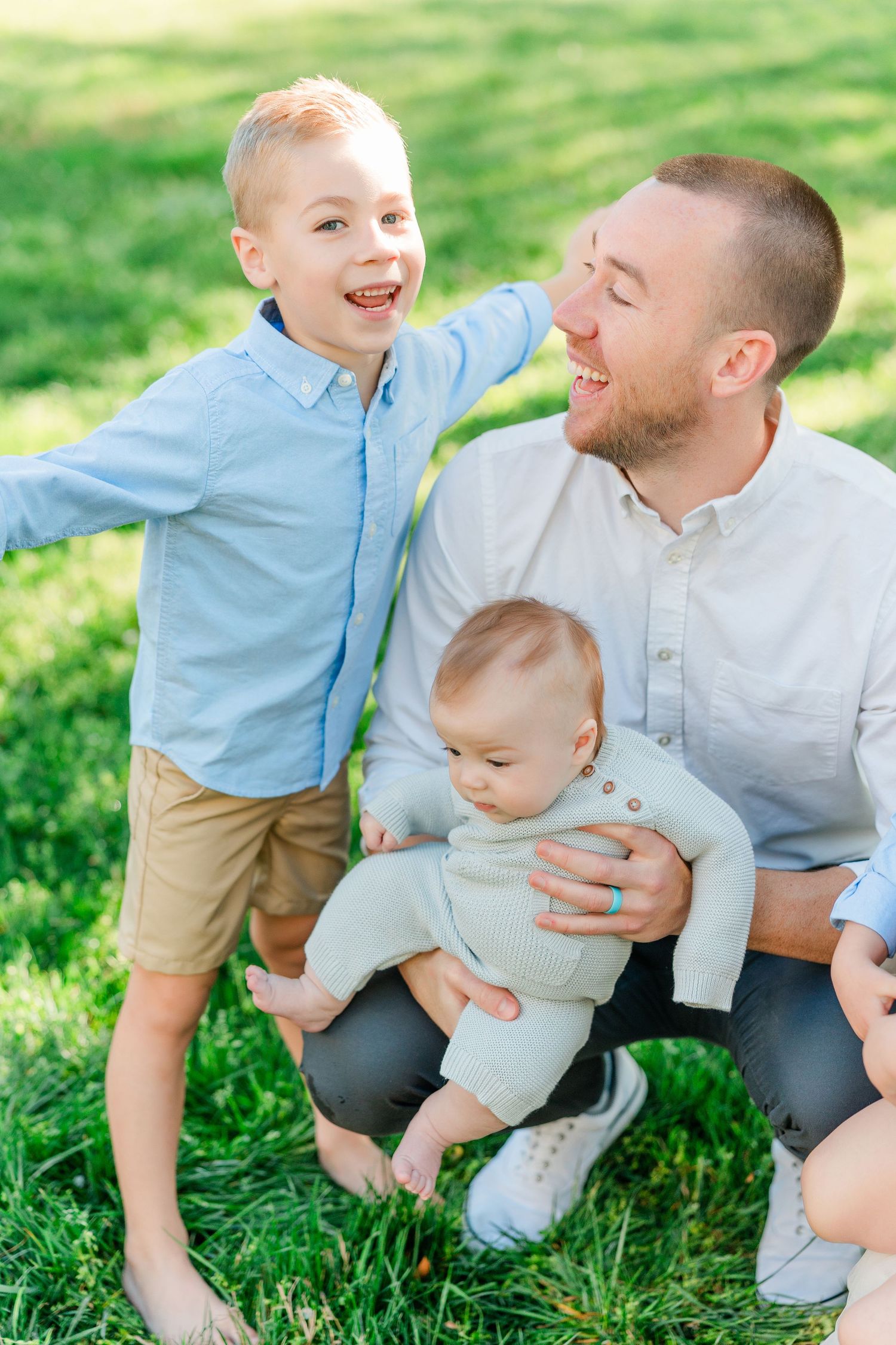 Candid family moments captured on grass showing playful interactions.