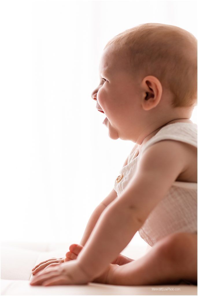 A series of five side-by-side photos showing a baby crawling in a diaper against a white background.