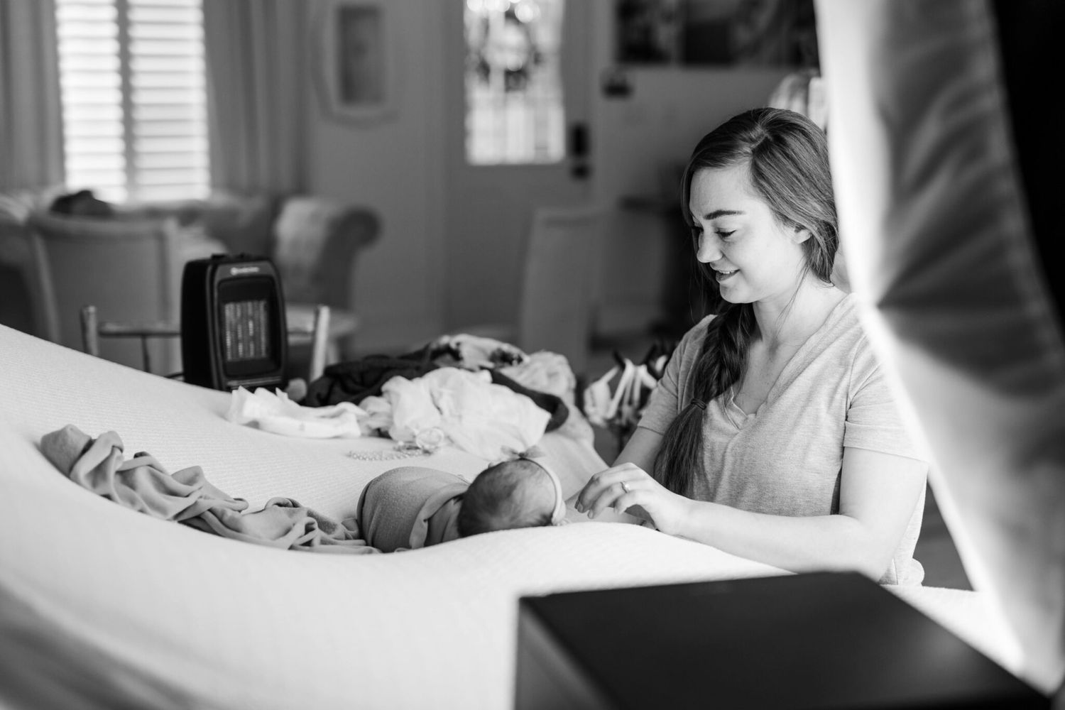 A series of black and white photographs showing a person lying in a hospital bed receiving medical care.