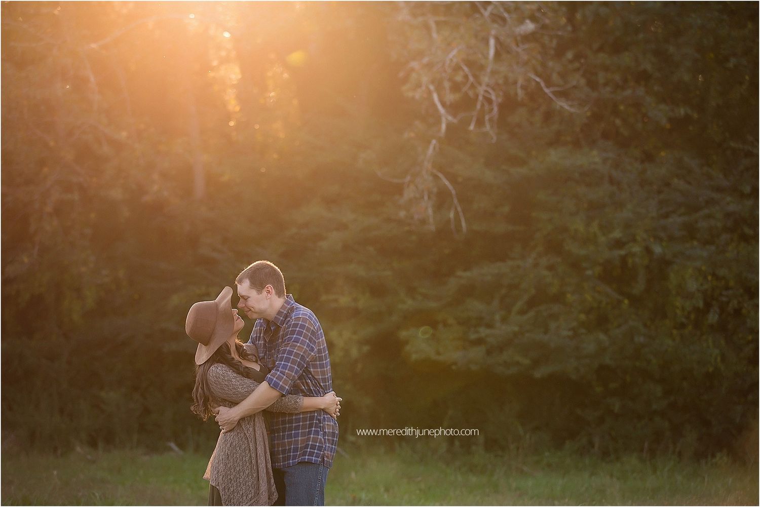 A romantic sunset photoshoot captures intimate moments between two people in a golden-lit natural setting.