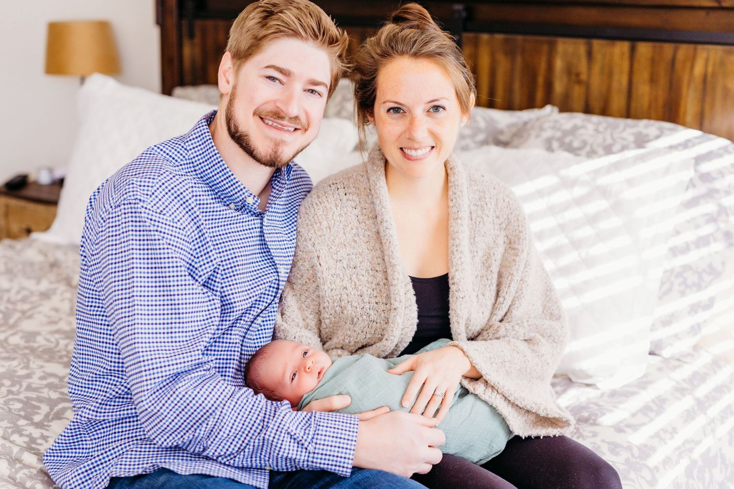A series of five connected photos showing tender moments with a newborn baby on a white bed.