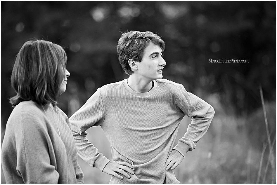Black and white portrait series showing a person in casual attire against a natural outdoor setting.