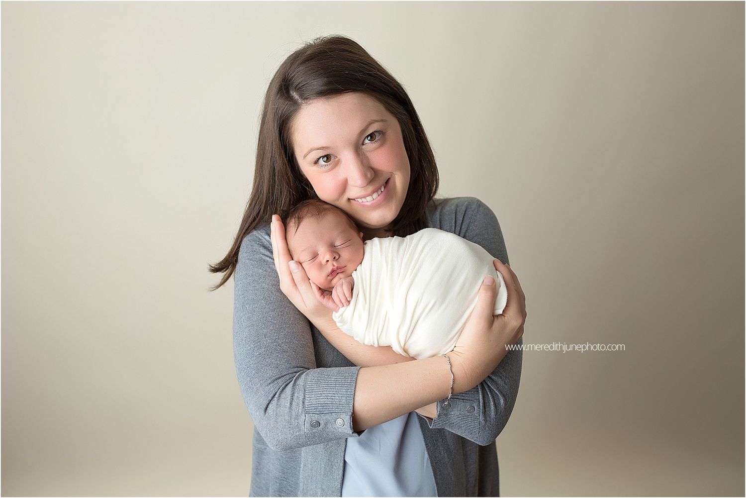 A tender newborn photography session shows intimate moments between parent and baby against neutral backgrounds.