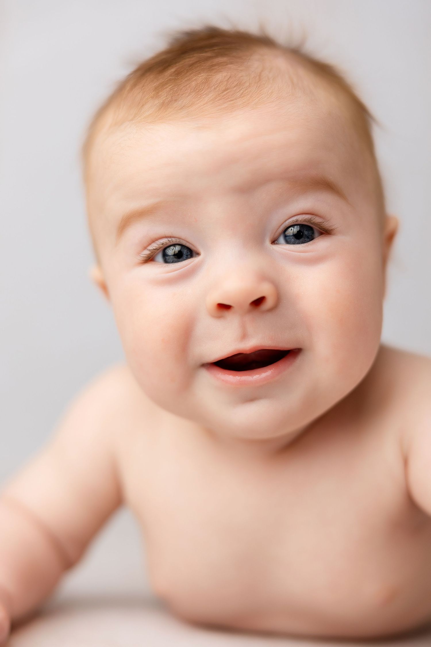 Close-up series showing sweet expressions and smiles against a light background.