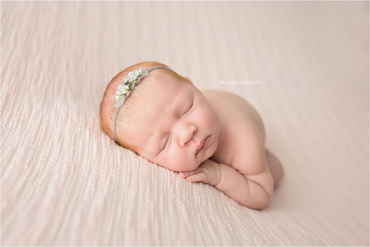 A series of peaceful newborn baby portraits on soft pink fabric showing different sleeping positions and angles.