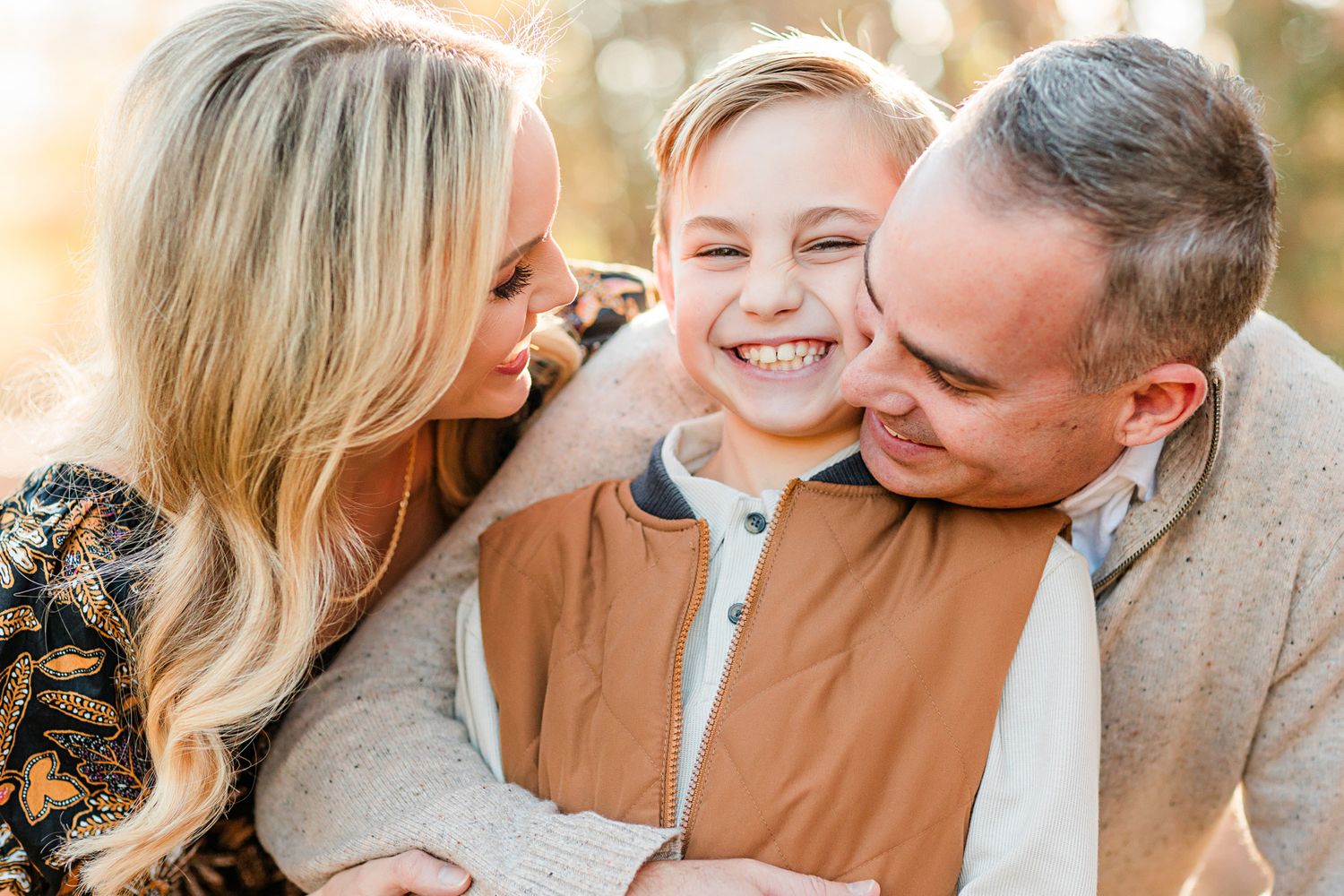 Family sharing a happy moment together outdoors during autumn.