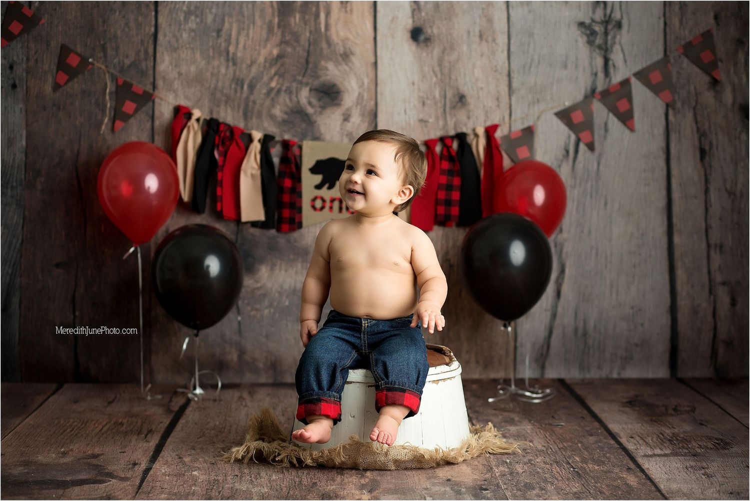 A series of cake smash photos showing a baby with red and black balloons against a rustic wooden backdrop.