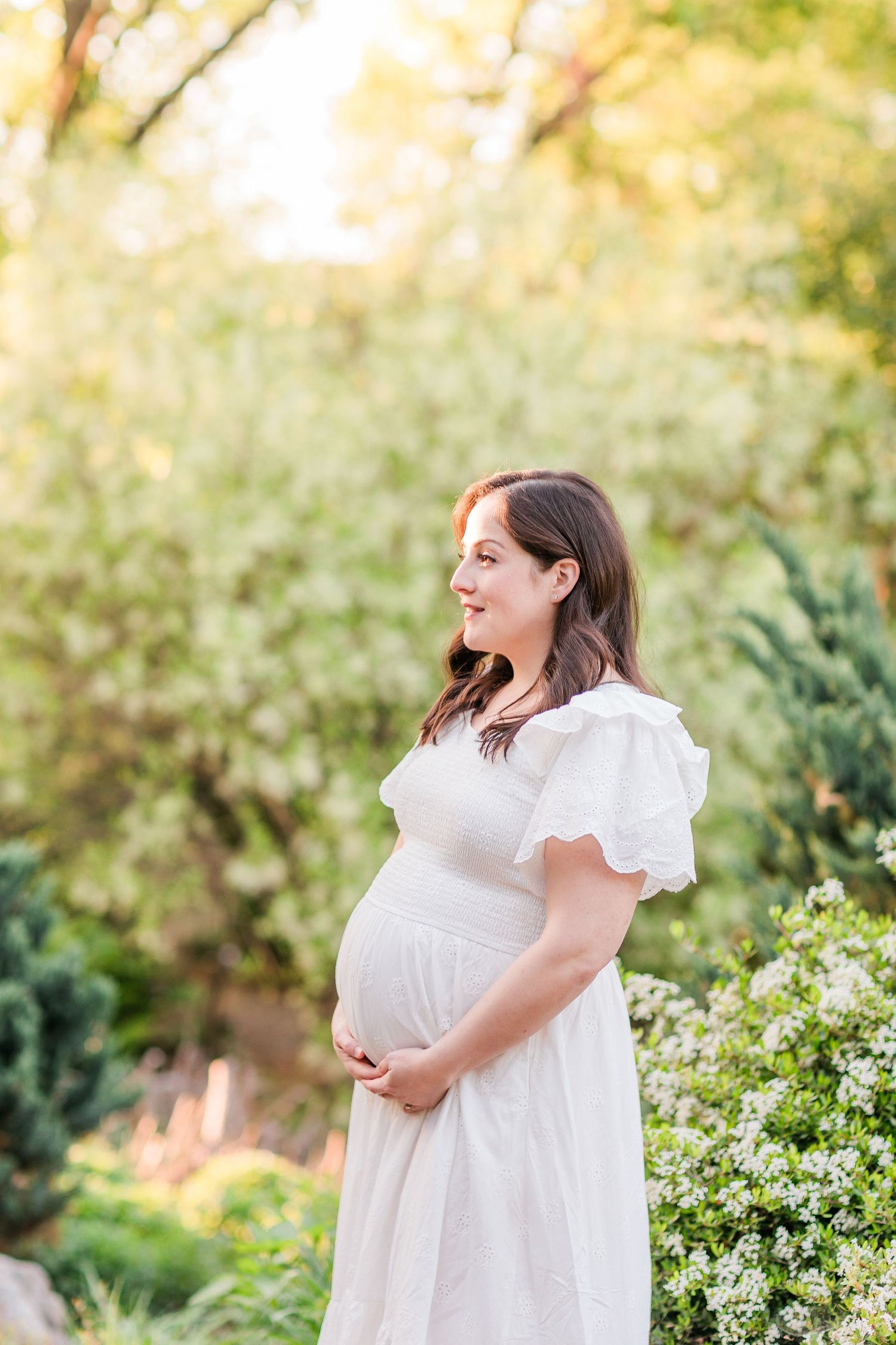 A series of four candid photos showing joyful moments in a garden setting with white dresses and blooming flowers.