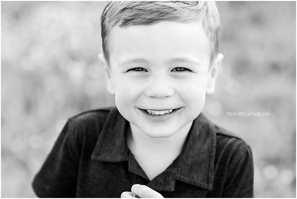 A series of black and white close-up portraits showing joyful expressions and genuine smiles.