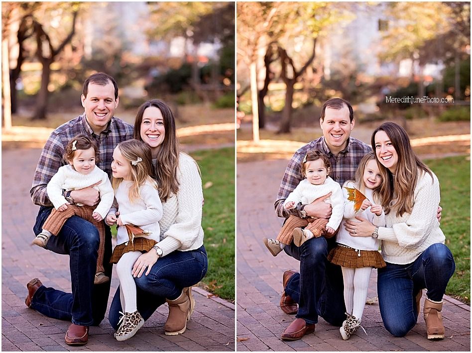 A couple and their dog pose together for outdoor family photos in a park during autumn.