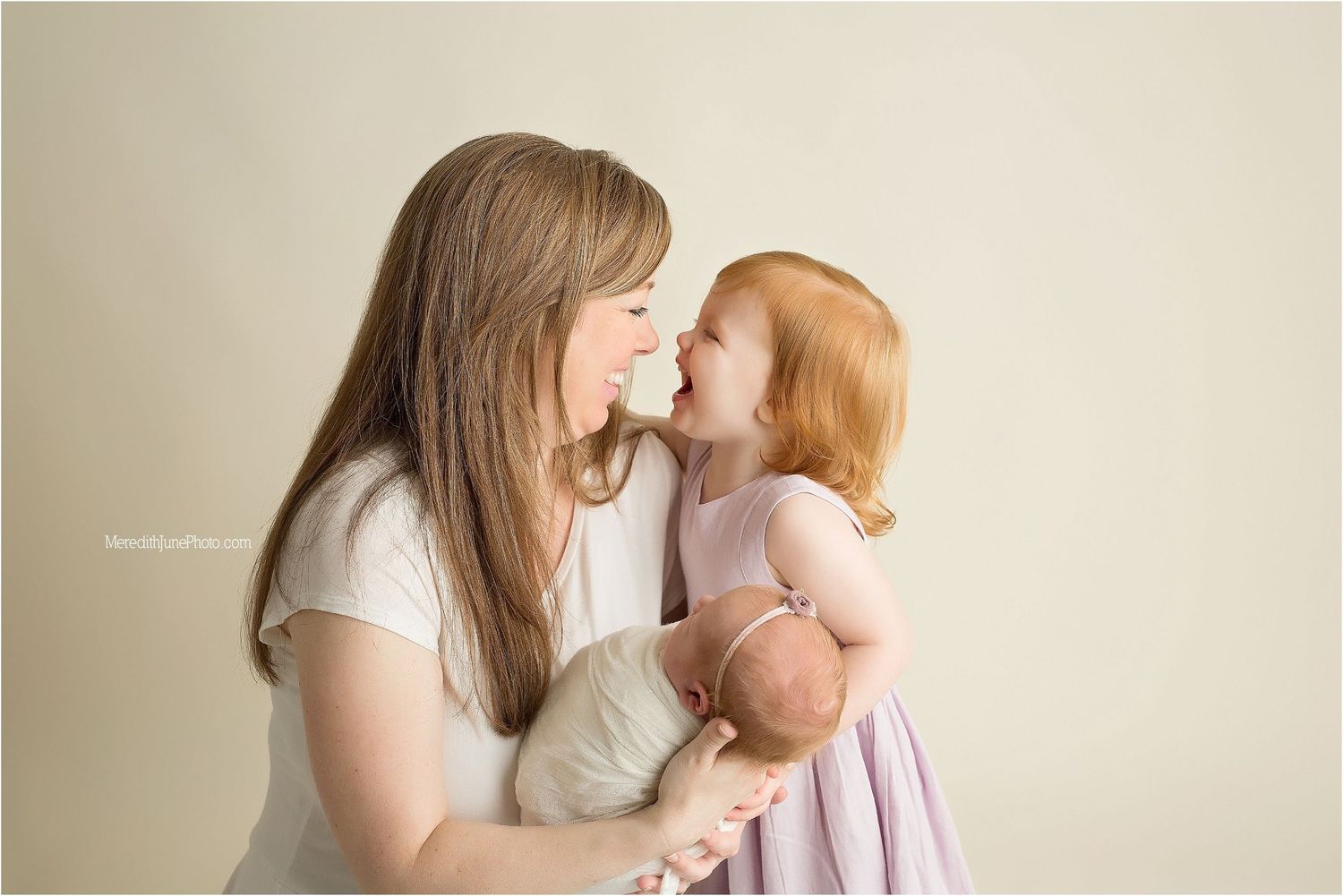 A tender moment between parent and child as they share an intimate embrace in soft natural lighting.