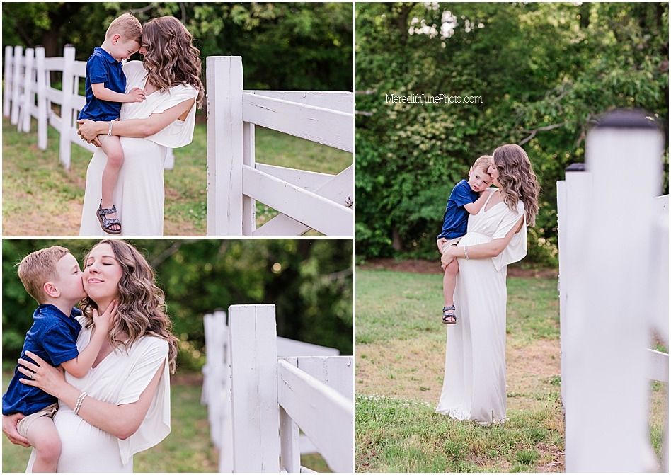 A romantic moment captured against a white fence in an outdoor garden setting.