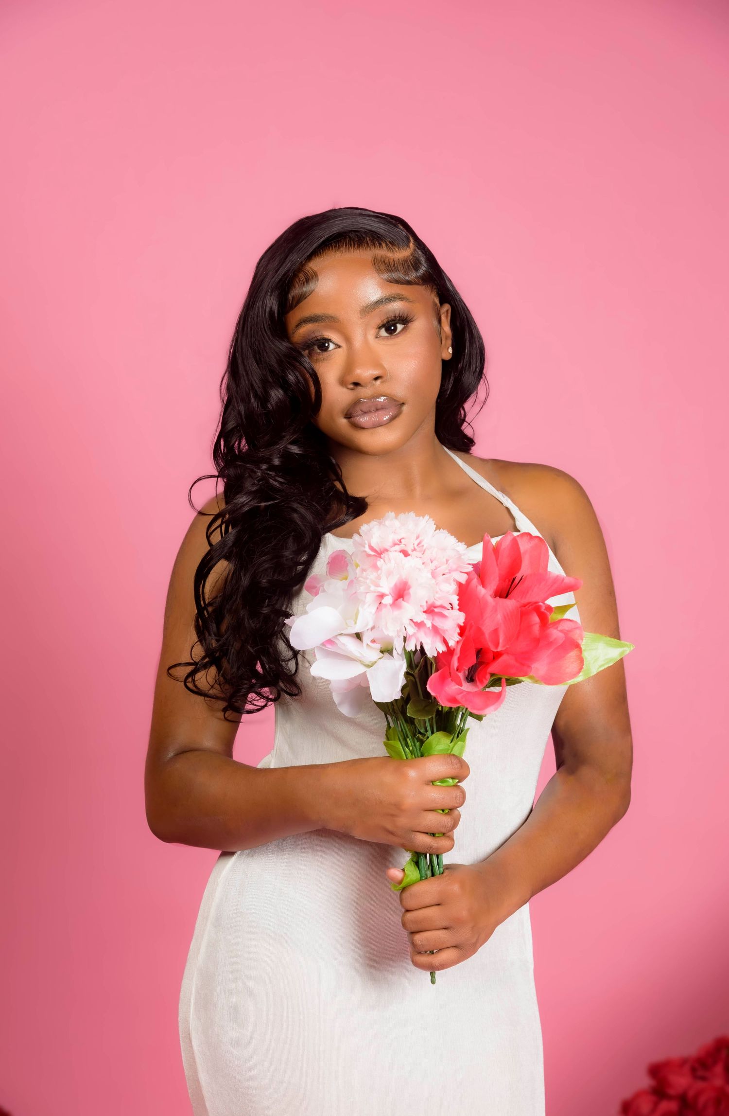 Portrait series against pink background featuring white dress and pink flowers.