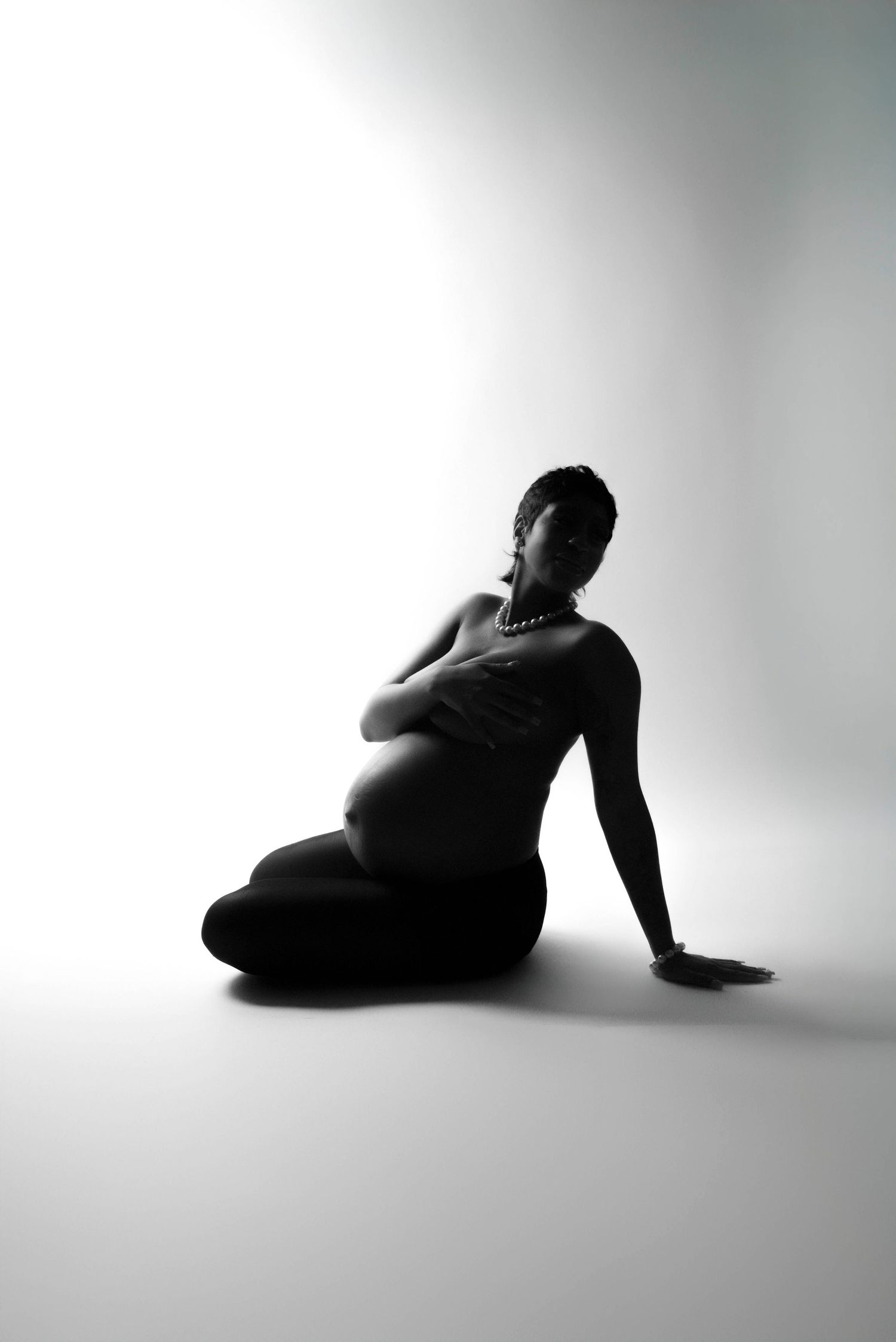 Minimalist black and white silhouette series showing reclining poses against white background.